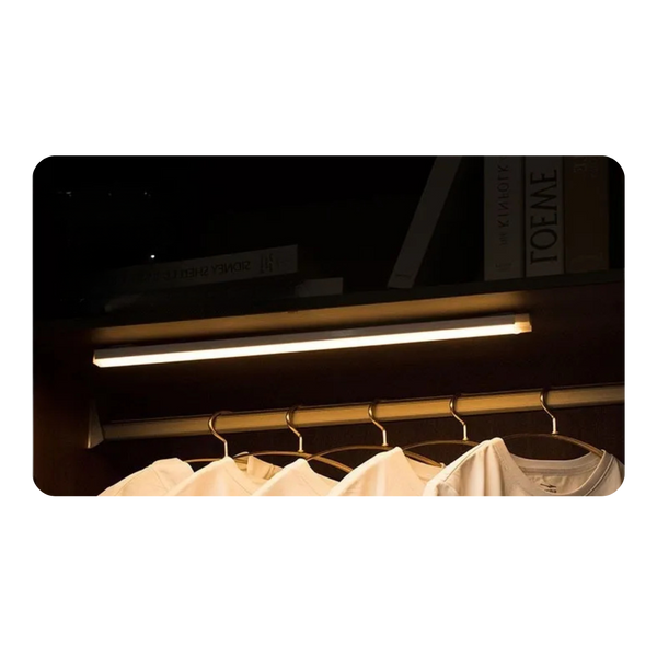 magnetic rechargeable infrared lamp illuminating a closet with hanging shirts and books.
